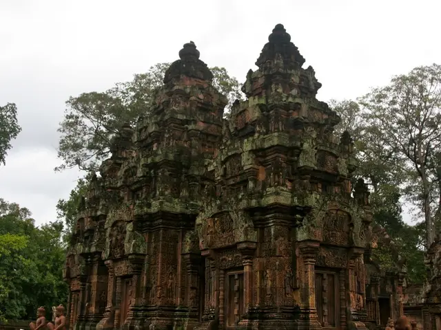 In this image there is an ancient temple, in the background there are trees and the sky.