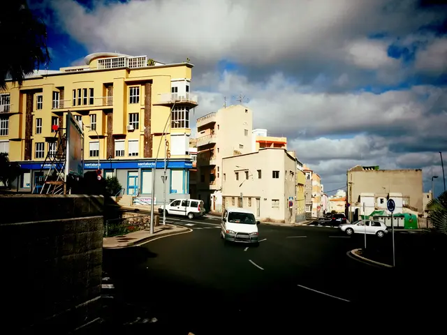 The picture is clicked on the street of a city. In the foreground of the picture there are...