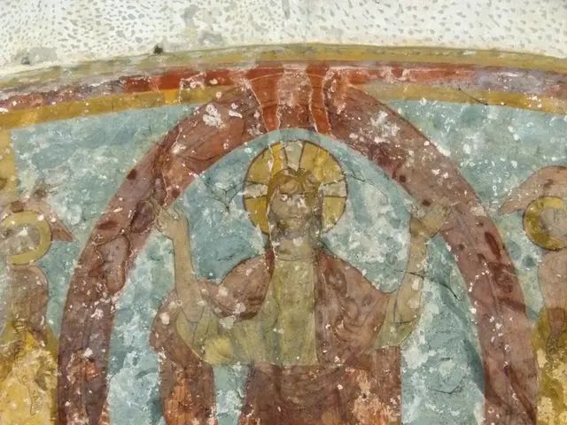 In this image I see the wall on which there is art and I see few people.