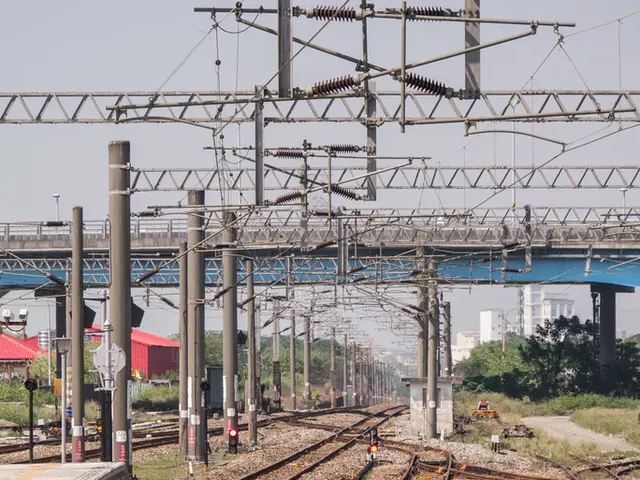 On the left side, there is a platform. On the right side, there are railway tracks. In the...